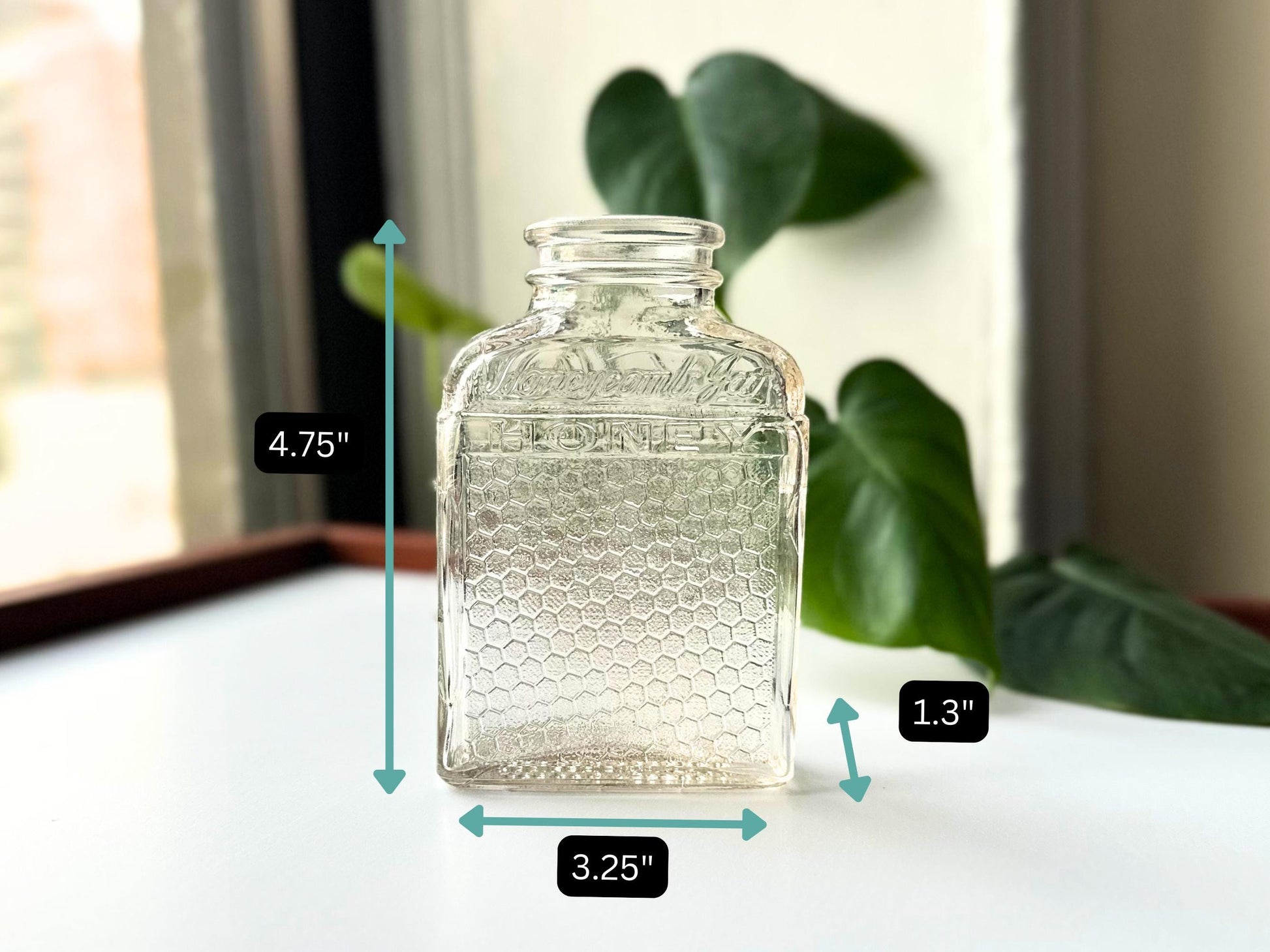 Flatlay image of the Lake Shore Honey jar with on-image measurements: 4.75" tall, 3.25" wide, 1.3" deep. The embossed front and honeycomb-textured sides are visible, with gentle surface wear giving it authentic vintage character. Great for eco-conscious decorators or collectors looking for exact sizing on this mid-century glass piece, ideal for fall vignettes or upcycled storage.