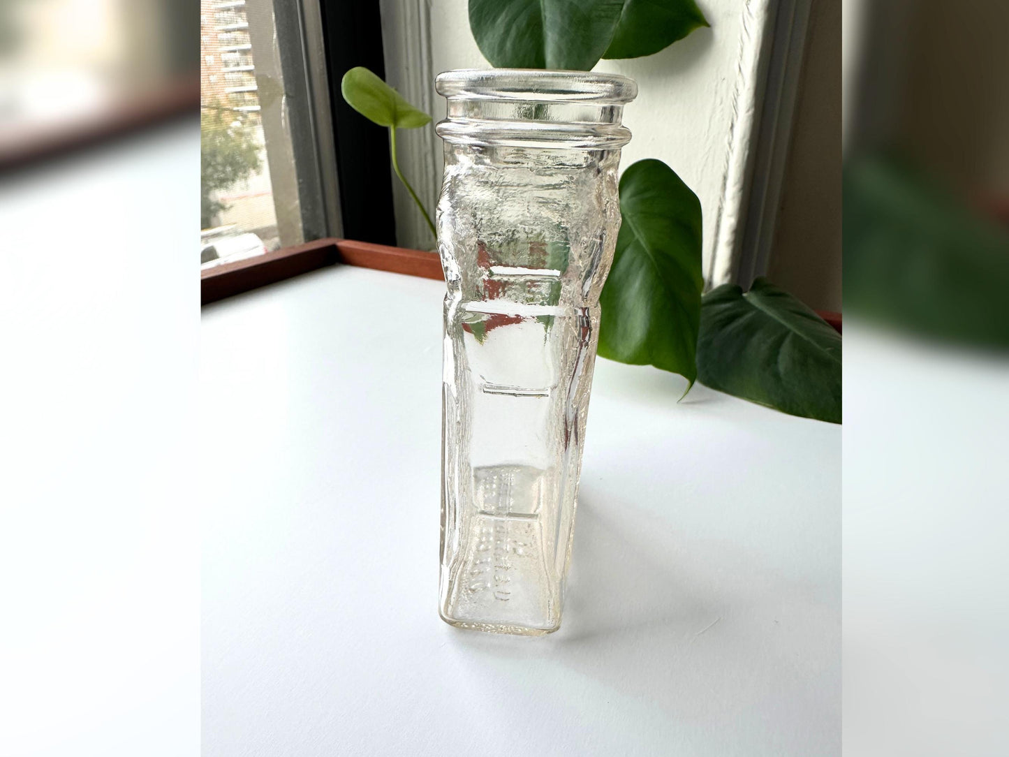 Angled side view of the Lake Shore Honey jar focusing on the deeply embossed honeycomb pattern along the full side panel. The textured glass catches light beautifully and the jar’s clear pink-tinted tone stands out in this shot. A great close-up for highlighting vintage detail, perfect for mid-century modern shelf styling or sustainable fall decor rooted in reclaimed materials.