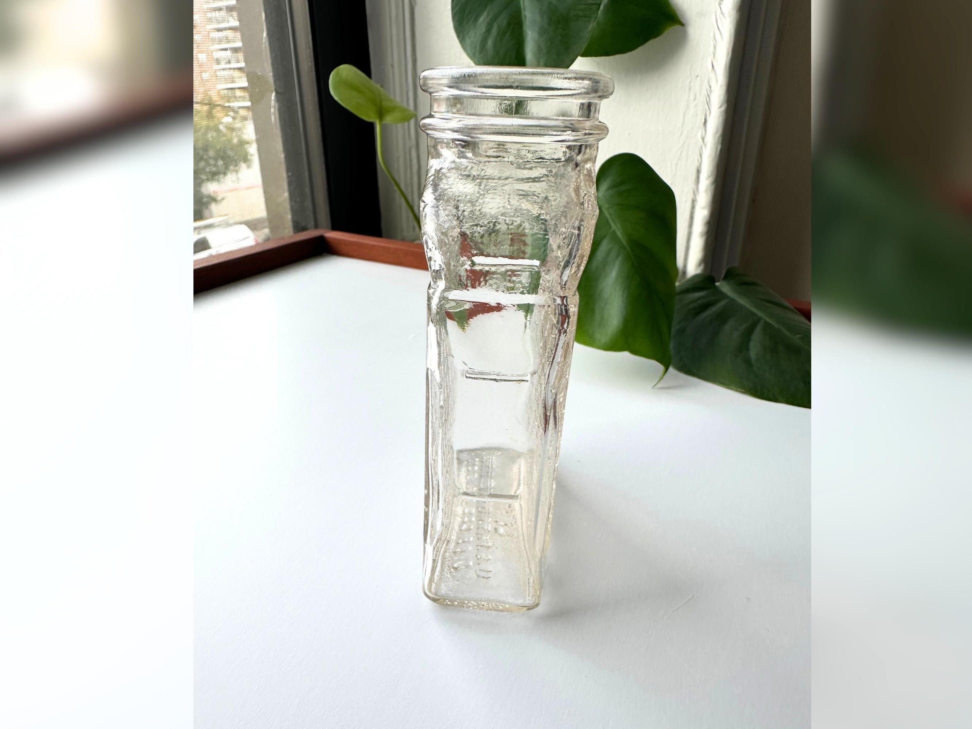 Angled side view of the Lake Shore Honey jar focusing on the deeply embossed honeycomb pattern along the full side panel. The textured glass catches light beautifully and the jar’s clear pink-tinted tone stands out in this shot. A great close-up for highlighting vintage detail, perfect for mid-century modern shelf styling or sustainable fall decor rooted in reclaimed materials.