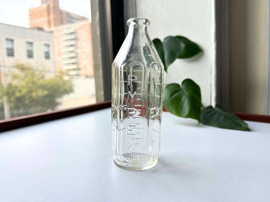 Vintage 1950s Pyrex baby bottle in clear glass with vertical embossed PYREX logo and measurement markings, 6.4 inches tall. Mid-century nursery decor perfect for cottagecore or farmhouse styling. Use as minimalist bud vase for dried flowers or display on shelf. Rescued sustainable vintage glassware from Brooklyn Sea Glass. American-made post-war era baby bottle ideal for gender-neutral nursery, baby shower gift, or vintage collector. Heat-resistant Pyrex quality with crisp embossing detail.