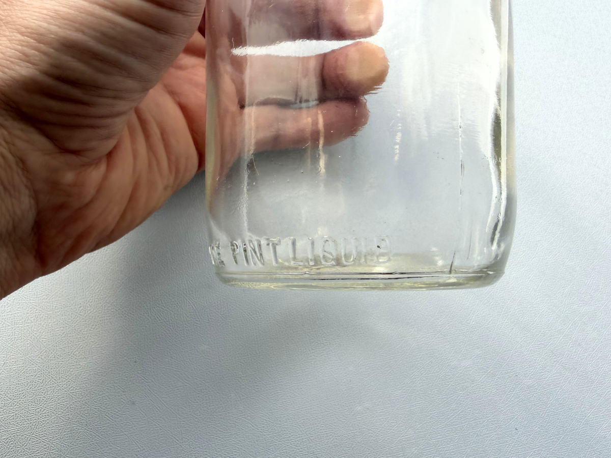 No Deposit Contents One Pint Liquid front embossing close-up, 1954 non-returnable milk bottle