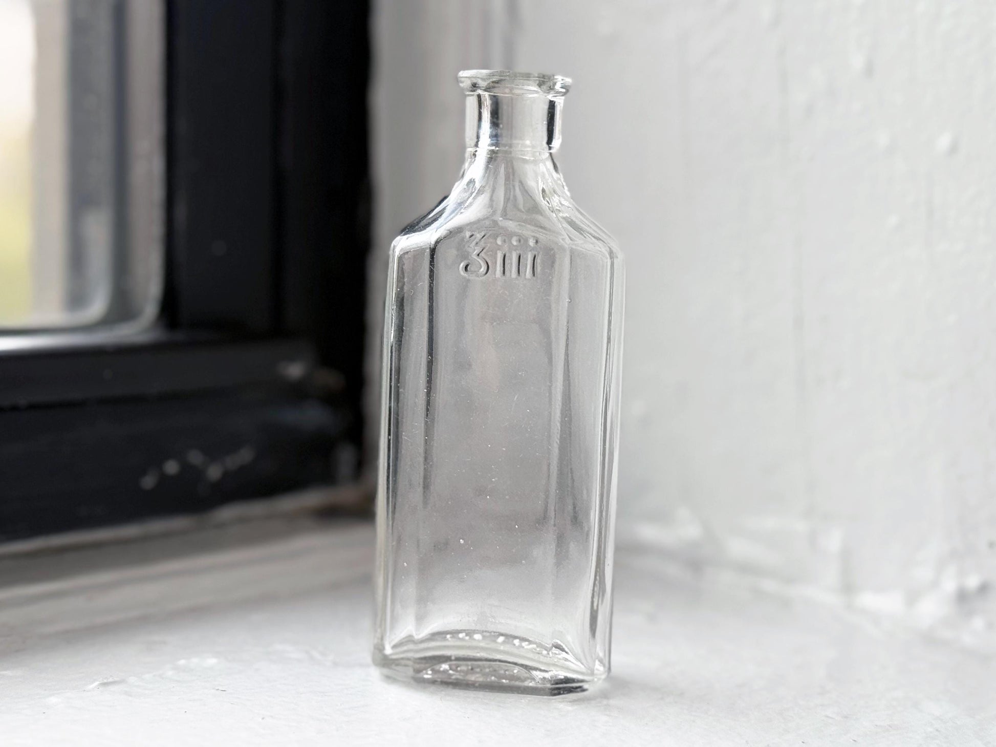 Owens Glass medicine bottle full front view showing 3iii embossing, early 20th century clear glass apothecary