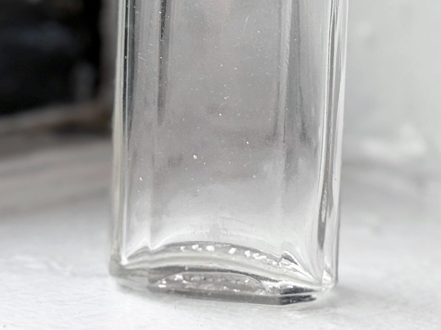 Owens Glass medicine bottle base corner detail showing minor wear, authentic early 20th century glass