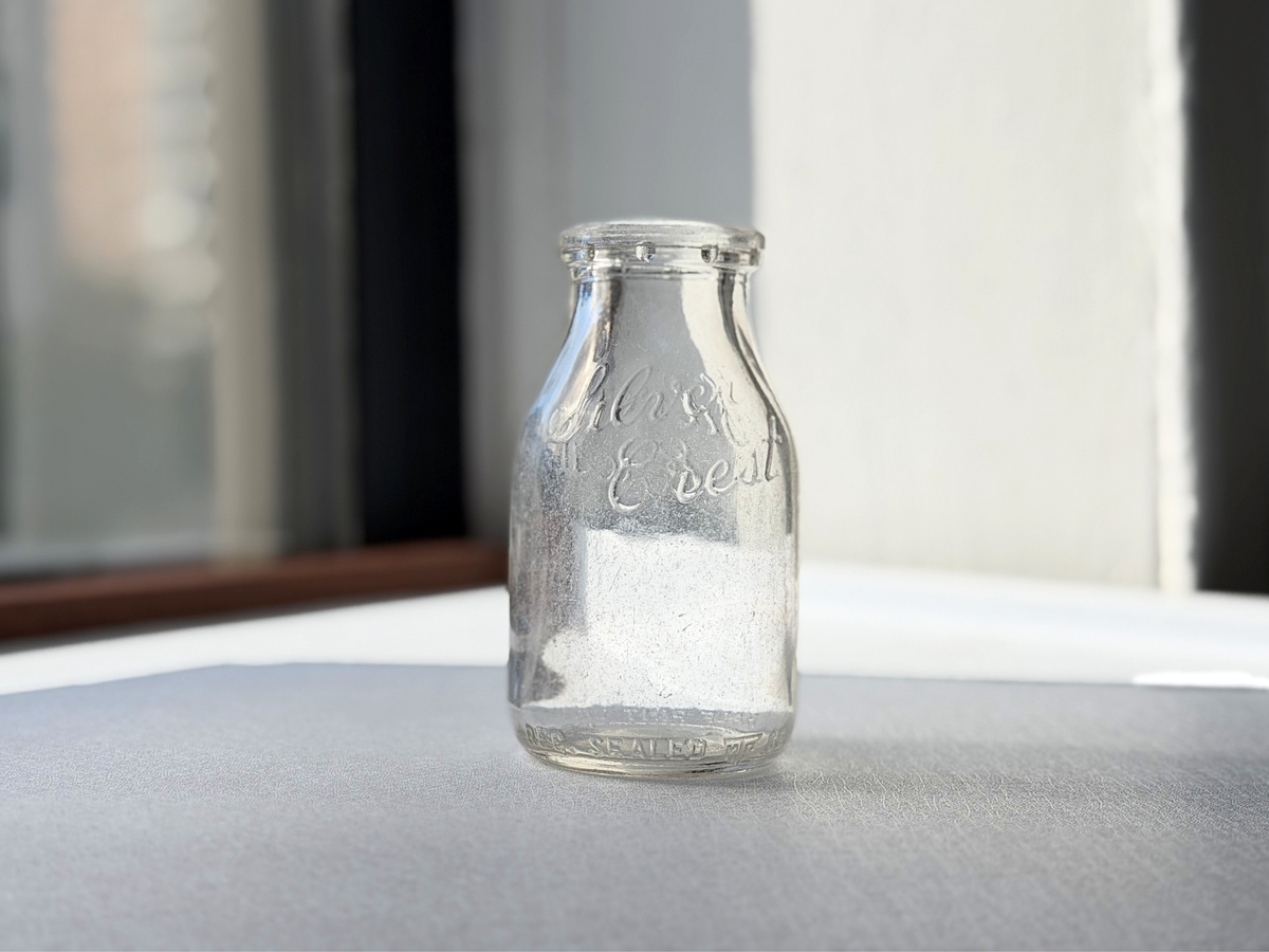 Silver Crest Dairy half pint milk bottle, Queens NY, angled view