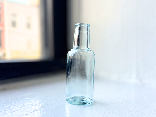 Tournades Kitchen Bouquet aqua glass bottle, angled view