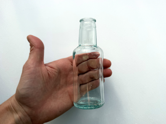 Hand holding Tournades Kitchen Bouquet bottle for scale