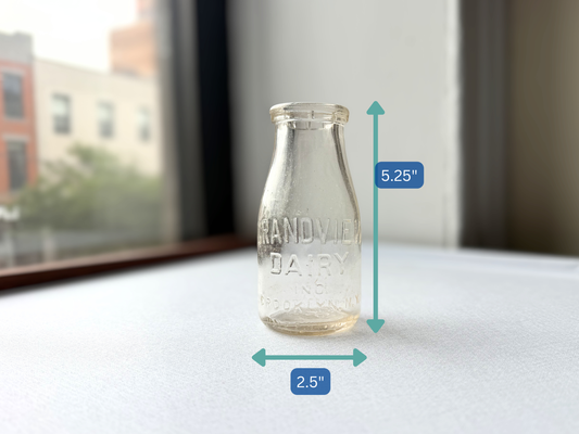 Vintage Grandview Dairy milk bottle shown with measurement markers indicating a height of 5.25 inches and width of 2.5 inches, illustrating its small, tidy scale ideal for a bud vase.