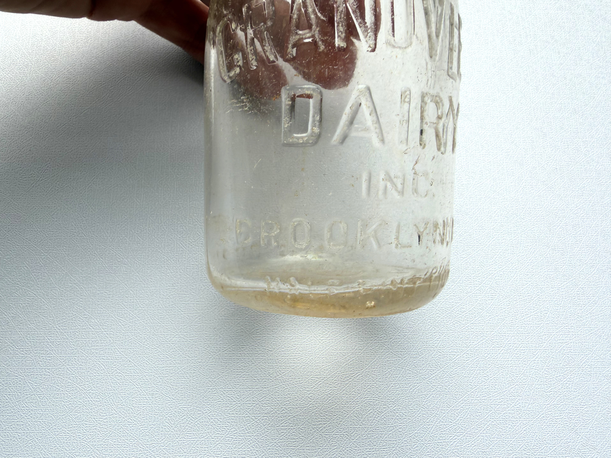 Close-up of the embossed base of a vintage Grandview Dairy milk bottle reading 51 Deposit Duraglas, confirming its 1951 production date and Owens-Illinois Duraglas glassmaking process.