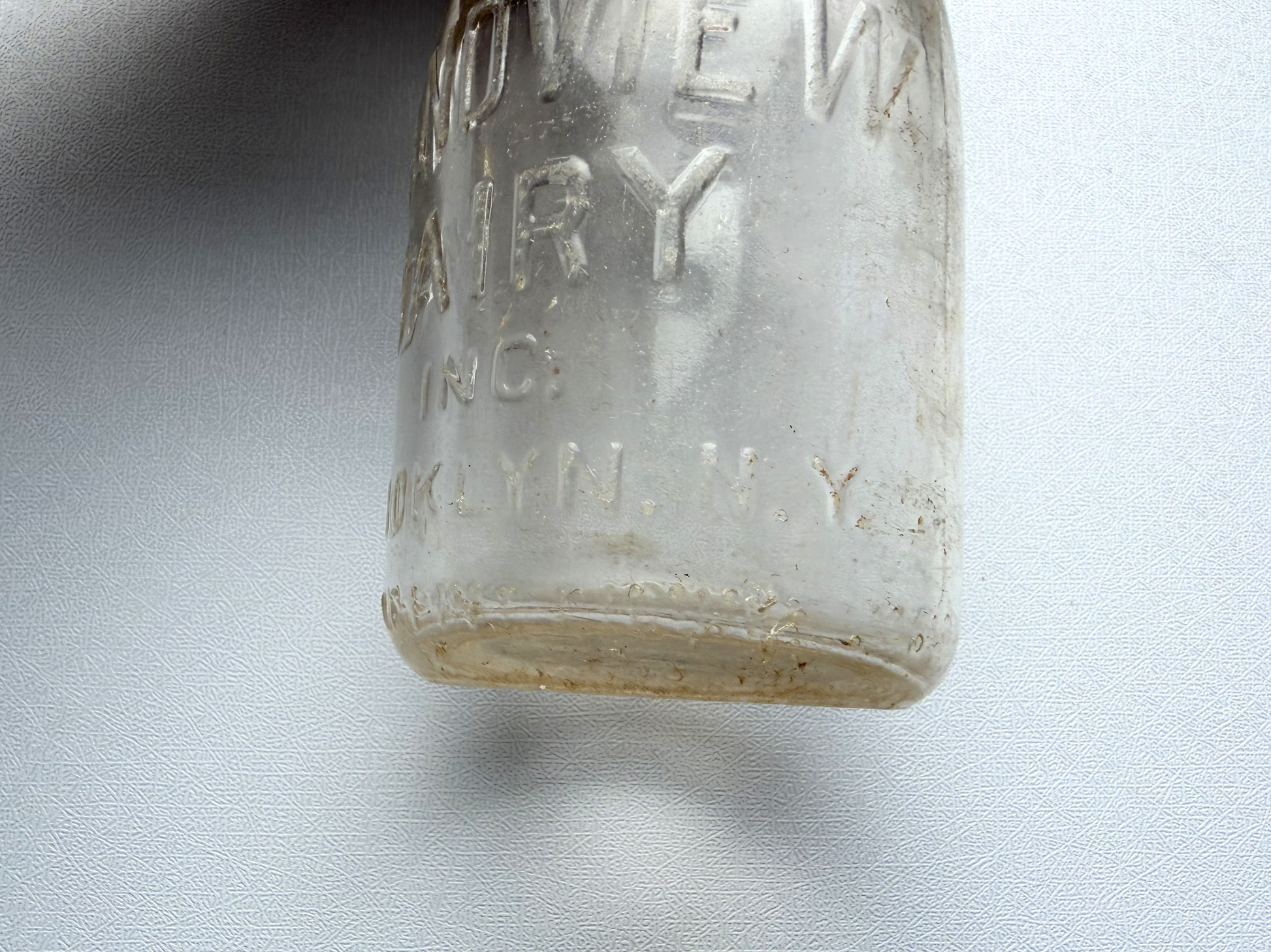 Close-up of the neck and shoulder area of a vintage Grandview Dairy milk bottle, showing the SEALED embossing on the back and the bottle's clean mid-century dairy design.