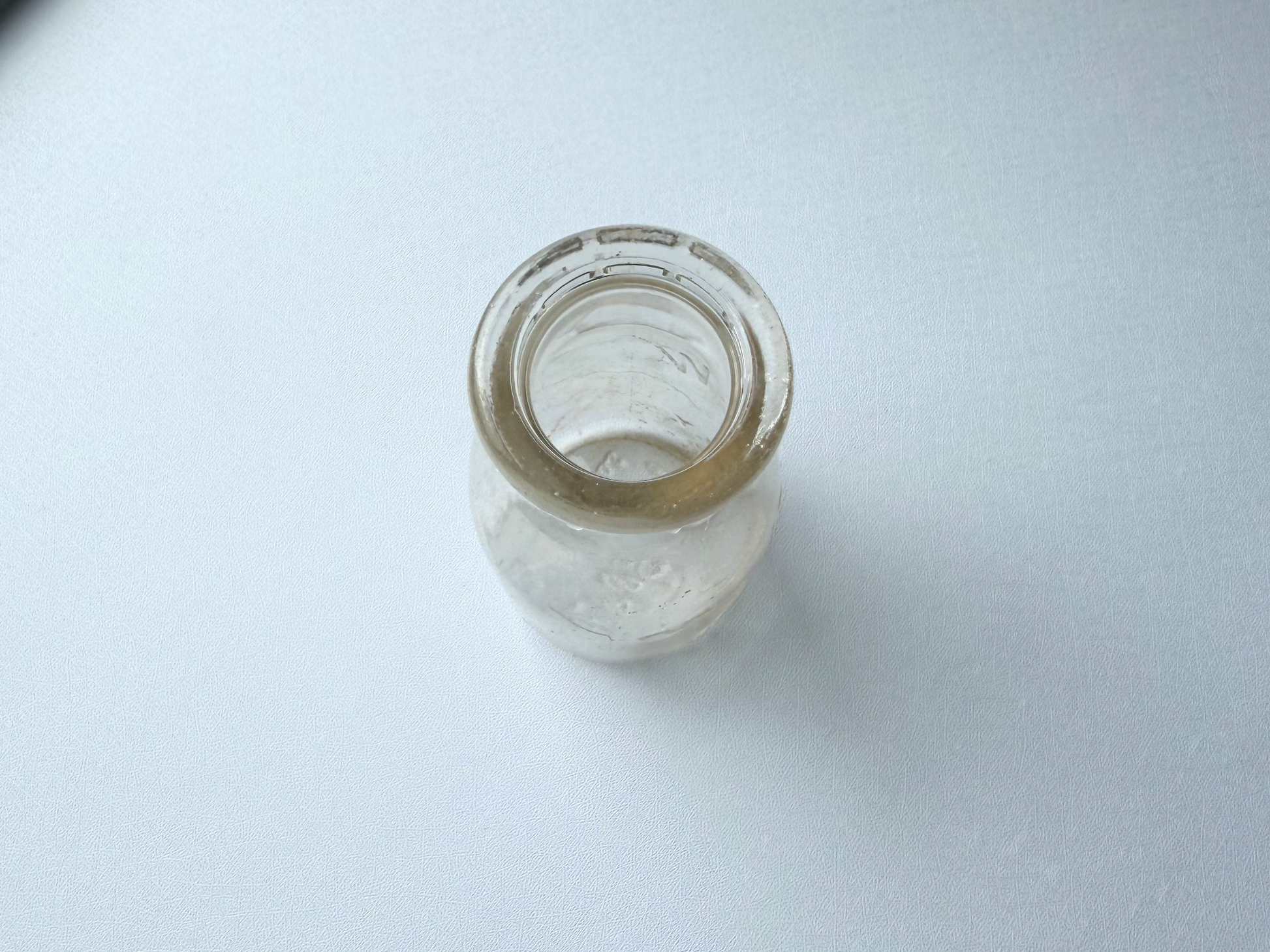 Top-down view of a vintage Grandview Dairy milk bottle, showing the narrow neck opening from above.
